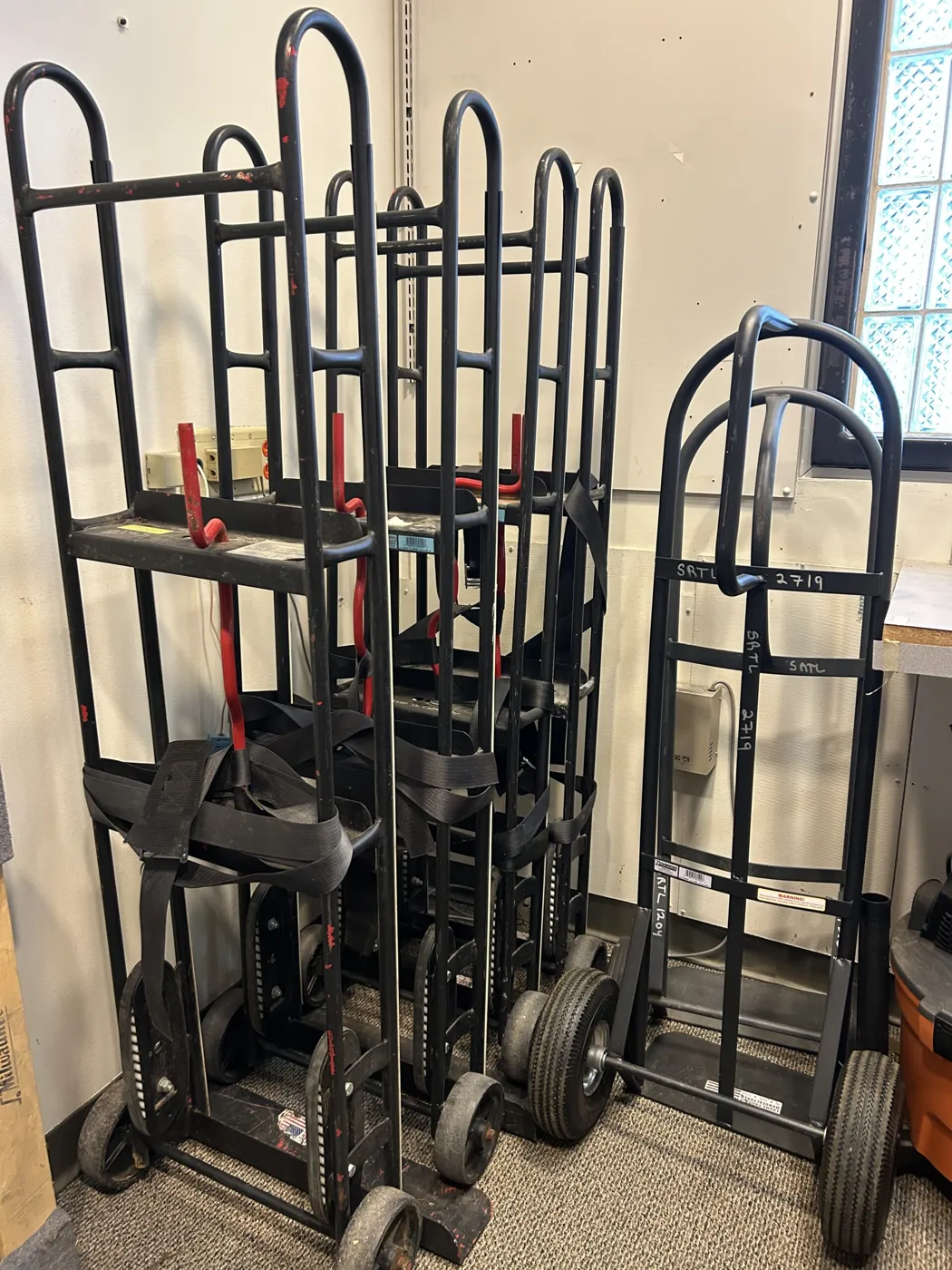 A row of hand trucks and dollies