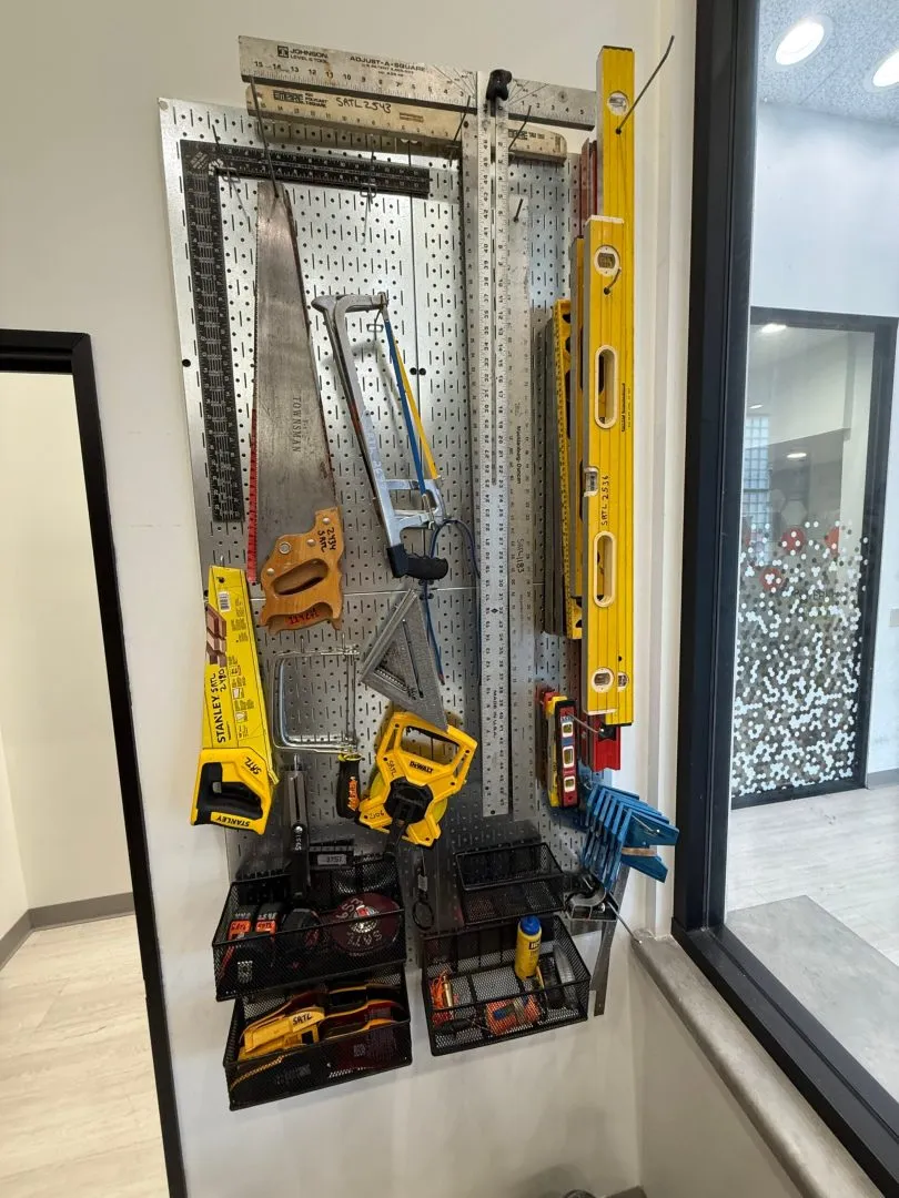 Pegboard with saws, levels and hand tools