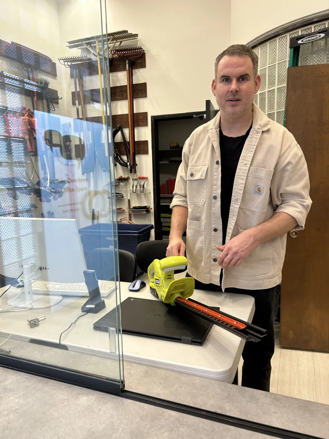 Member returning a hedge trimmer at the front desk